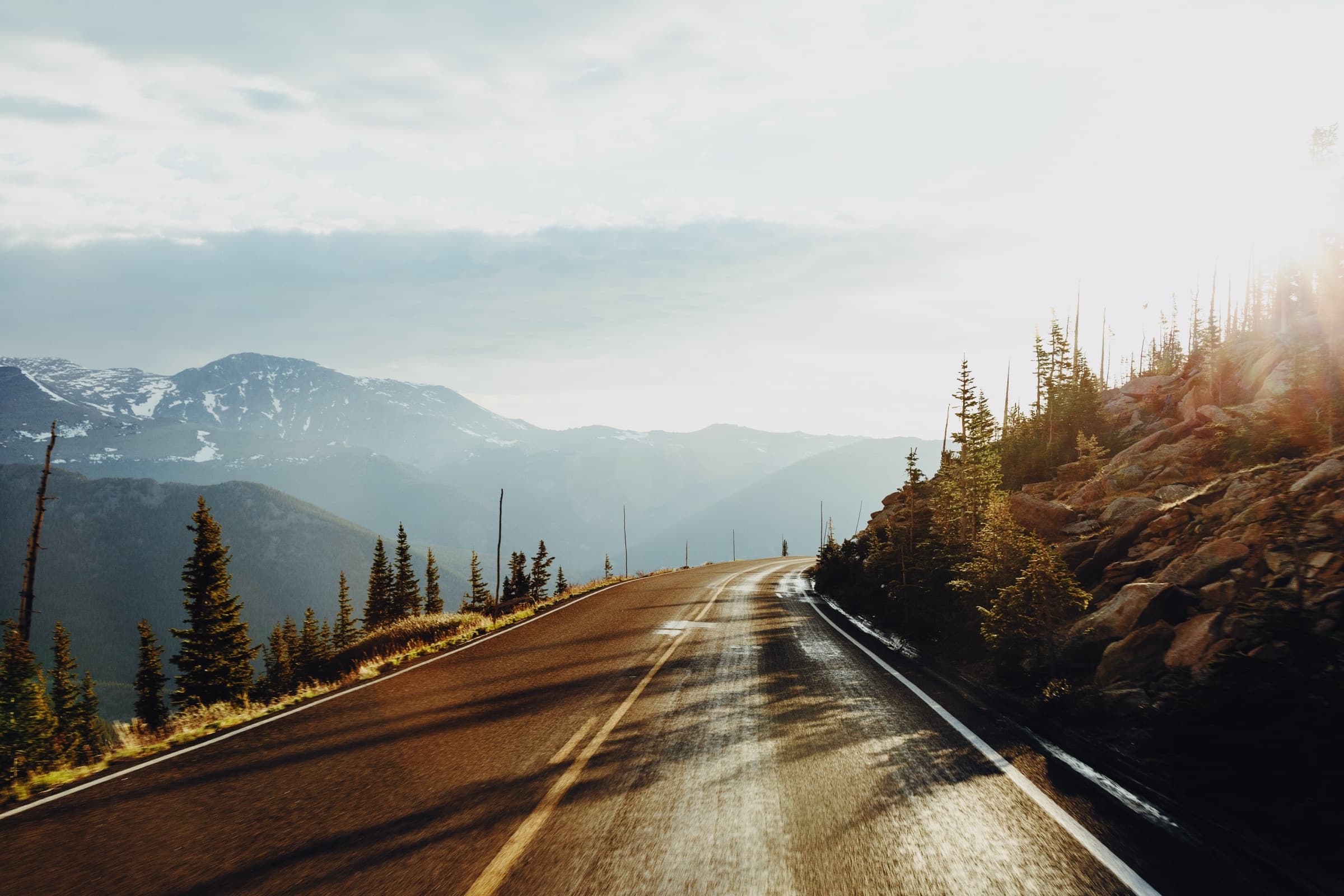 A mountain road winding toward the Rockies