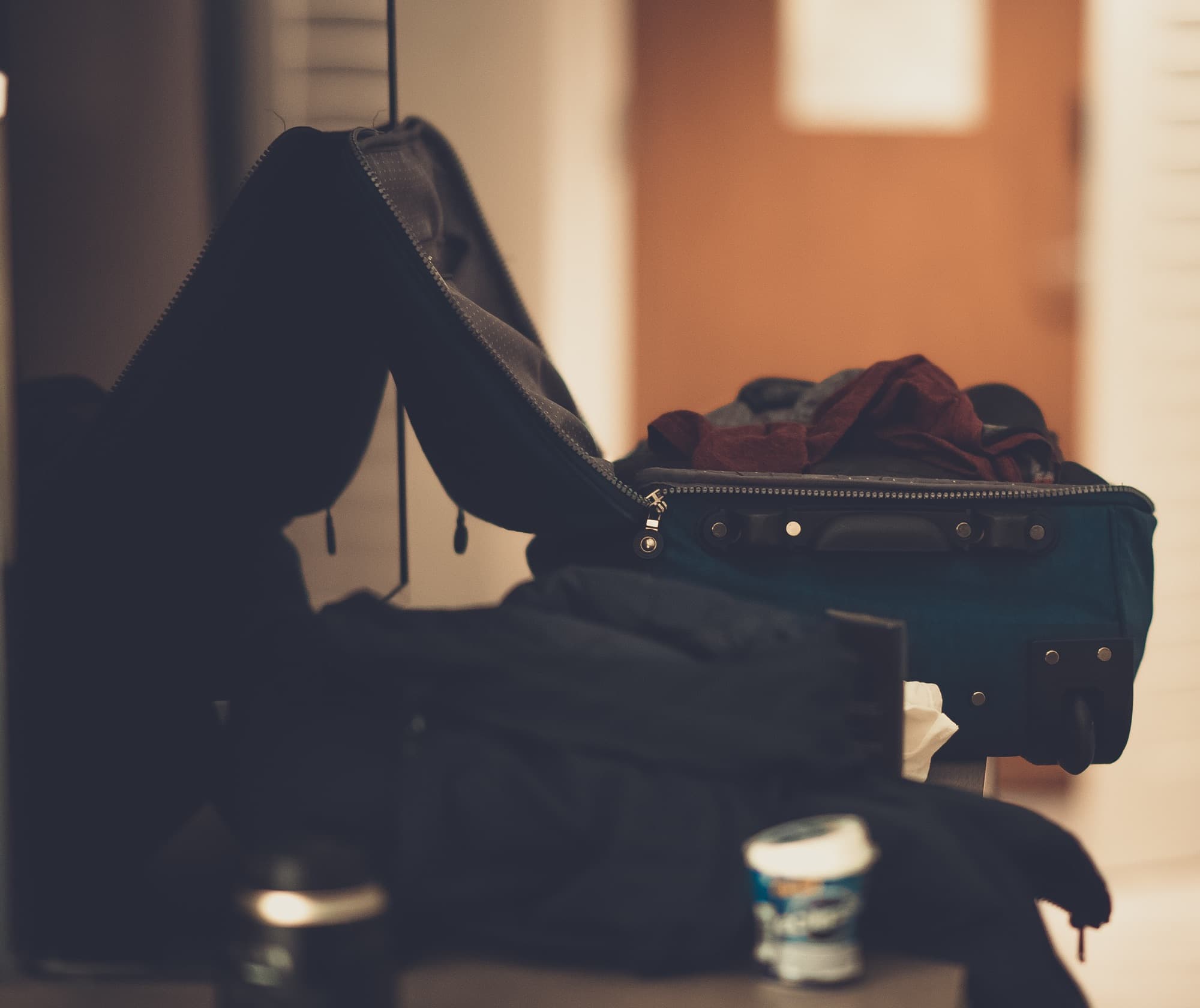 A half-packed open suitcase with folded clothes inside